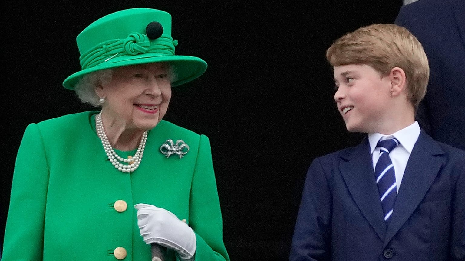 Britain's Queen Elizabeth II smiles at Prince George on the Buckingham Palace balcony during the Platinum Jubilee Pageant in London, Sunday, June 5, 2022
