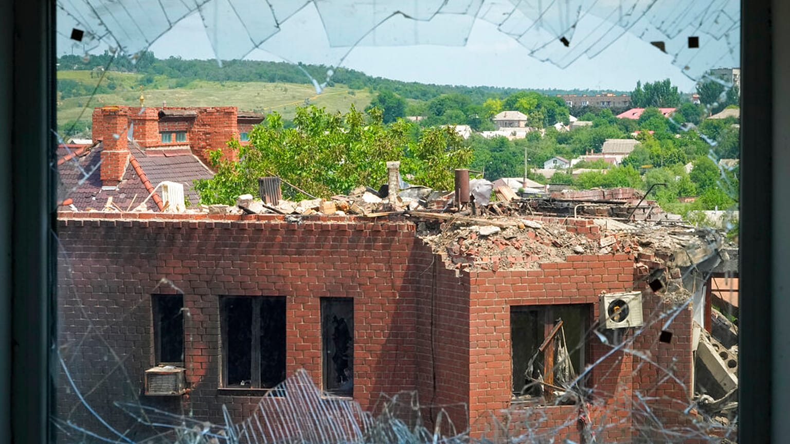 A heavily damaged house following Russian night shelling is seen through a broken window, in the town of Bakhmut, Donetsk region, Ukraine