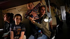 Yana Skakova and her son Yehor who fled from Lysychansk with other people sit in an evacuation train at the train station in Pokrovsk, eastern Ukraine, Saturday, May 28, 2022.