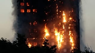 In this Wednesday, June 14, 2017 file photo, smoke and flames rise from the Grenfell Tower building on fire in London. 