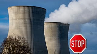 Steam rises from the cooling tower of the nuclear power plant of Gundremmingen, Bavaria, Dec. 31, 2021.