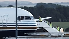 Members of the staff board a plane reported by British media to be first to transport migrants to Rwanda, at MOD Boscombe Down base in Wiltshire, Britain, June 14, 2022.