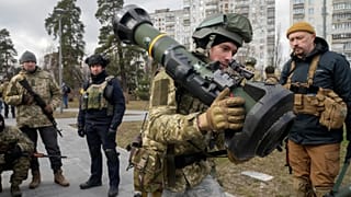 A Ukrainian Territorial Defence Forces member holds an NLAW anti-tank weapon, in the outskirts of Kyiv, Ukraine, Wednesday, March 9, 2022