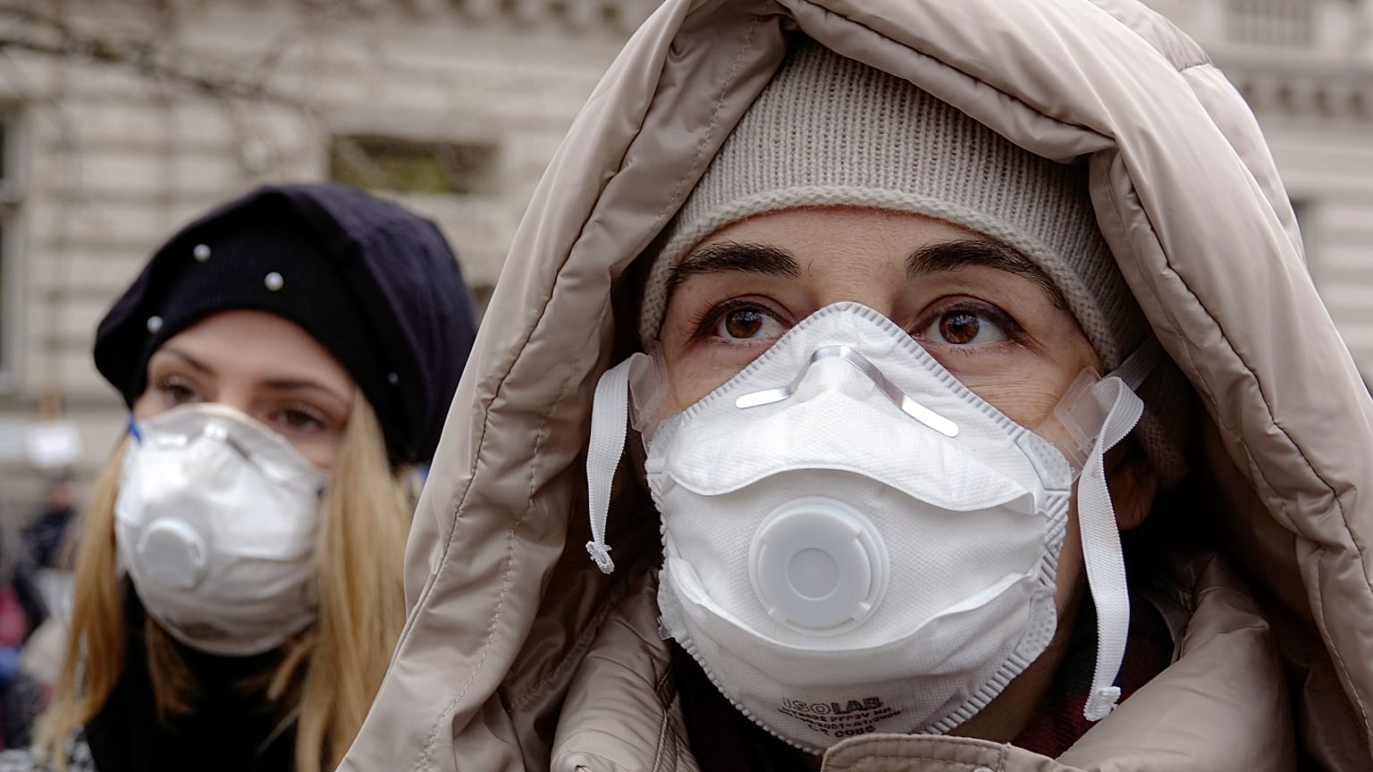 Women wearing face masks take part in a protest against air pollution, in Sarajevo, Bosnia, Monday, Jan. 20, 2020.