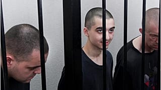 الأسرى الثلاثة المحكوم عليهم بالإعدام في دونيسك المغربي إبراهيم سعدون في الوسط والبريطانيين أيدن أسلين وشون بينر. 