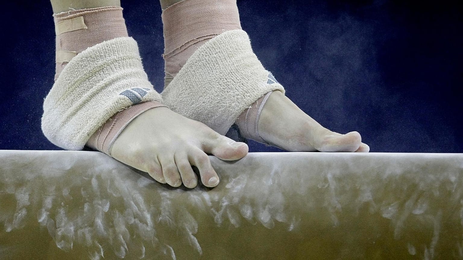 FILE: A gymnast balances on the beam during a practice session for the World Gymnastics at the O2 arena in London, Monday, Oct. 12, 2009.