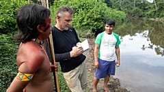 November 16, 2019 Veteran foreign correspondent Dom Phillips (C) talks to two indigenous men in Aldeia Maloca Papiú, Roraima State, Brazil.