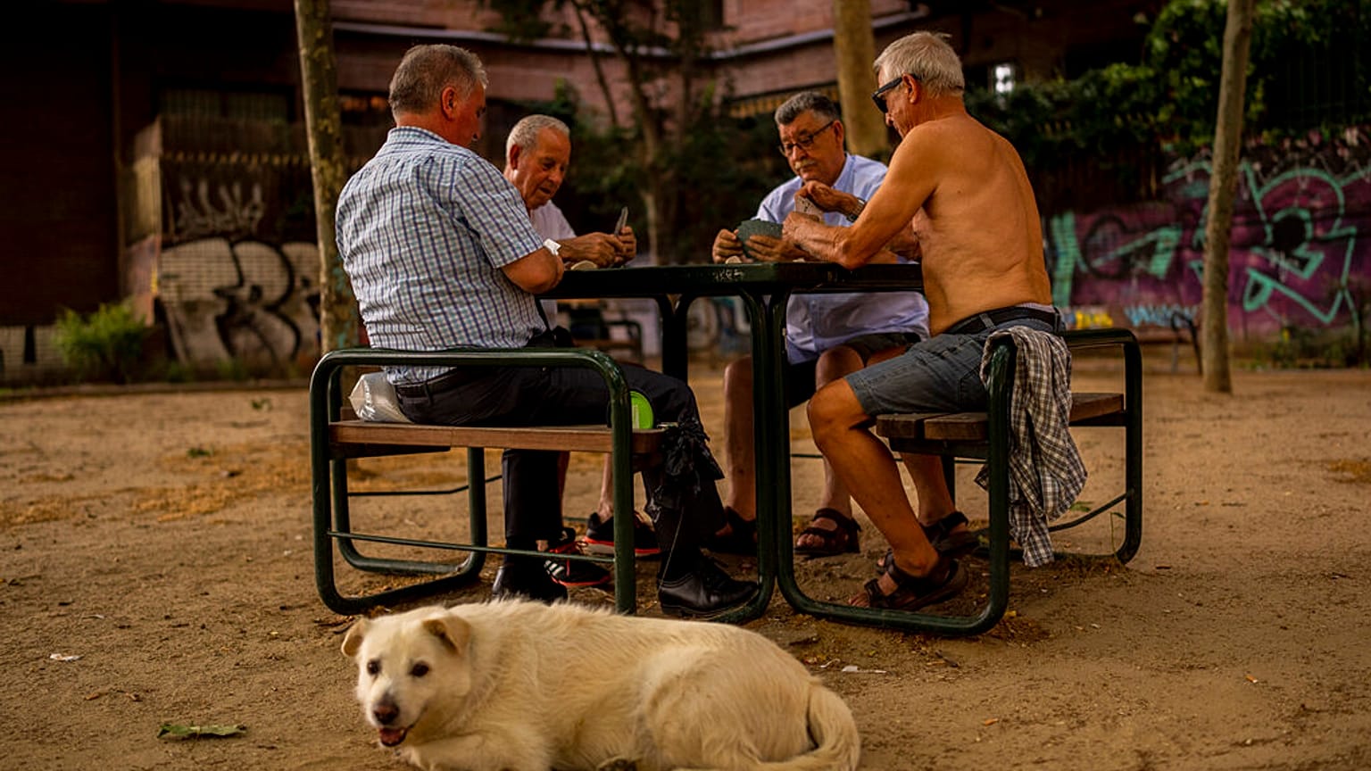Men play cards during a hot day in Madrid, Spain, June 17, 2022. 