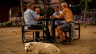 Men play cards during a hot day in Madrid, Spain, June 17, 2022. 