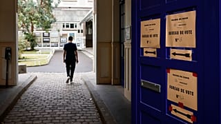 A voter arrives at a voting station in Paris on 19 June 2022.