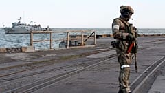A Russian serviceman stands guarding an area of the Mariupol Sea Port in Mariupol, eastern Ukraine, Friday, May 27, 2022