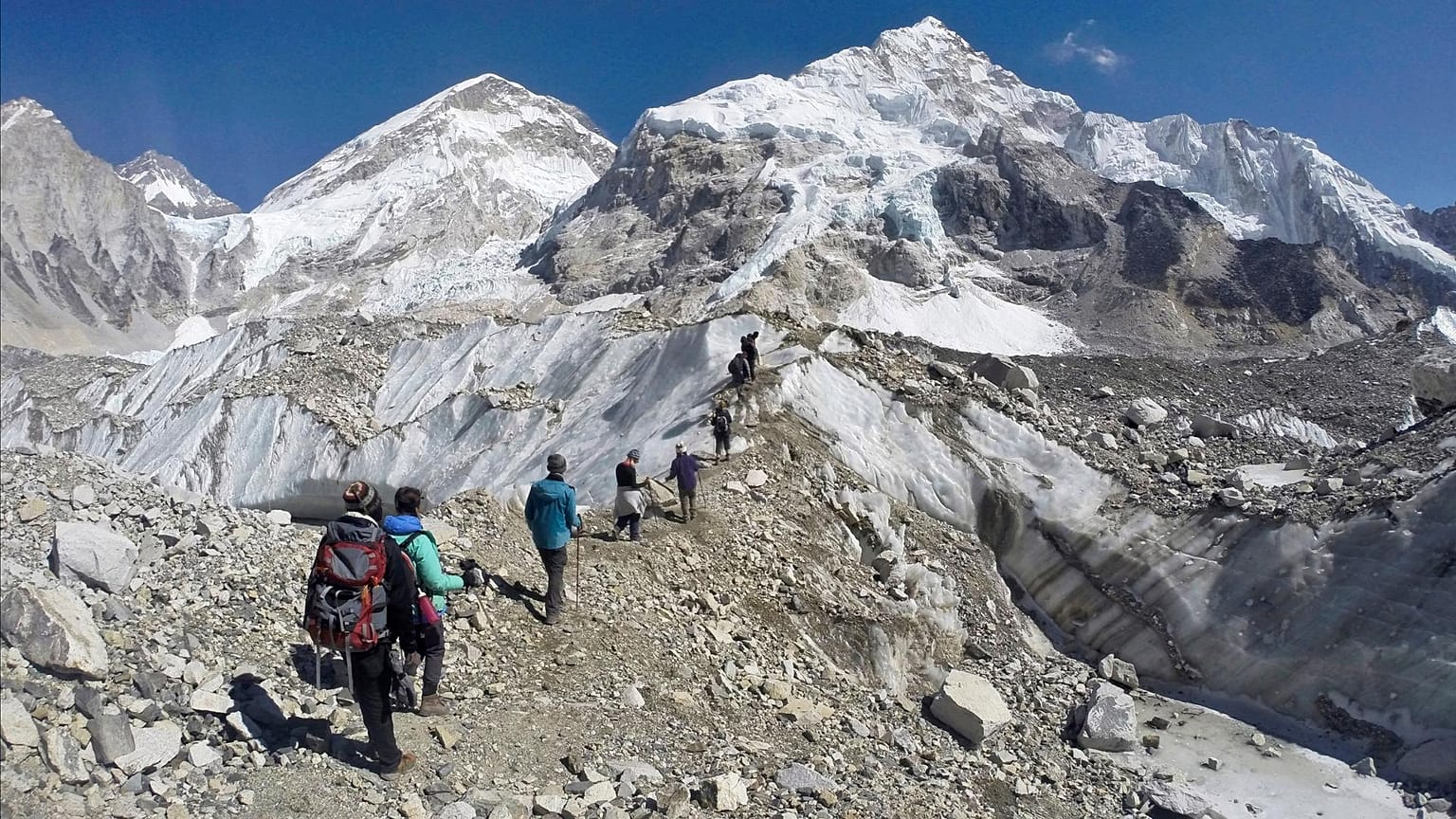 Trekkers pass through a glacier at the Mount Everest base camp, Nepal.