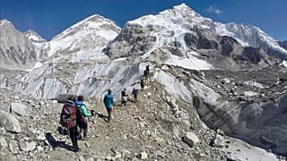 Trekkers pass through a glacier at the Mount Everest base camp, Nepal.