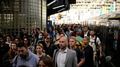 Passengers disembark from one of the few trains to arrive this morning at Waterloo railway station in London