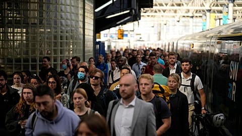 Passengers disembark from one of the few trains to arrive this morning at Waterloo railway station in London