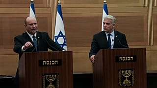 Israeli Prime Minister Naftali Bennett (L), speaks during a joint statement with Foreign Minister Yair Lapid, at the Knesset, Israel's parliament, in Jerusalem, June 20, 2022.
