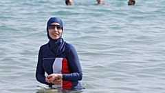 Karima, wearing a full-body burkini swimsuit, swims in Cannes after the call to support the wearing of burkinis by businessman and political activist Rachid Nekkaz.