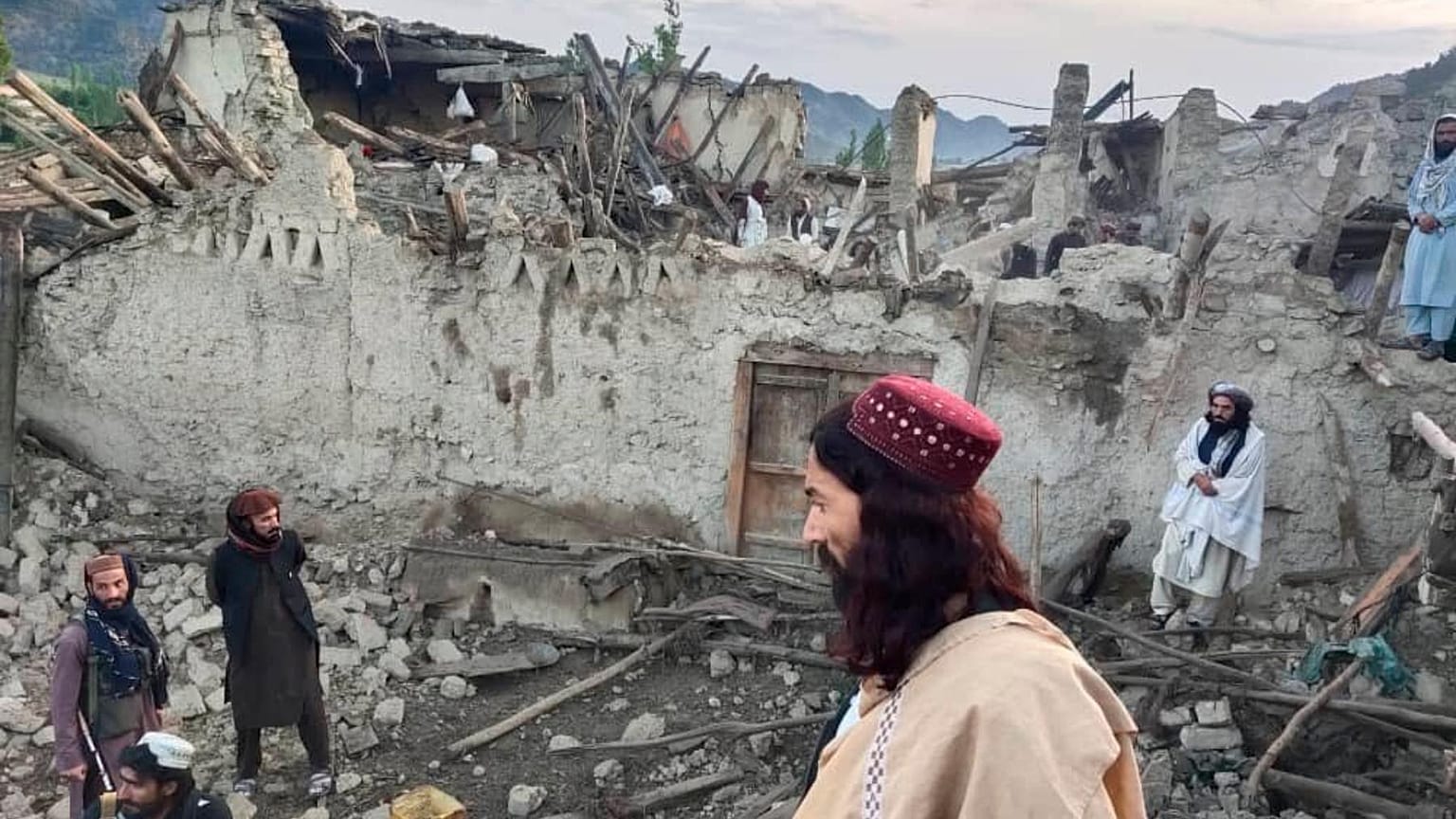 Afghans look at destruction caused by an earthquake in the province of Paktika, eastern Afghanistan, Wednesday, June 22, 2022