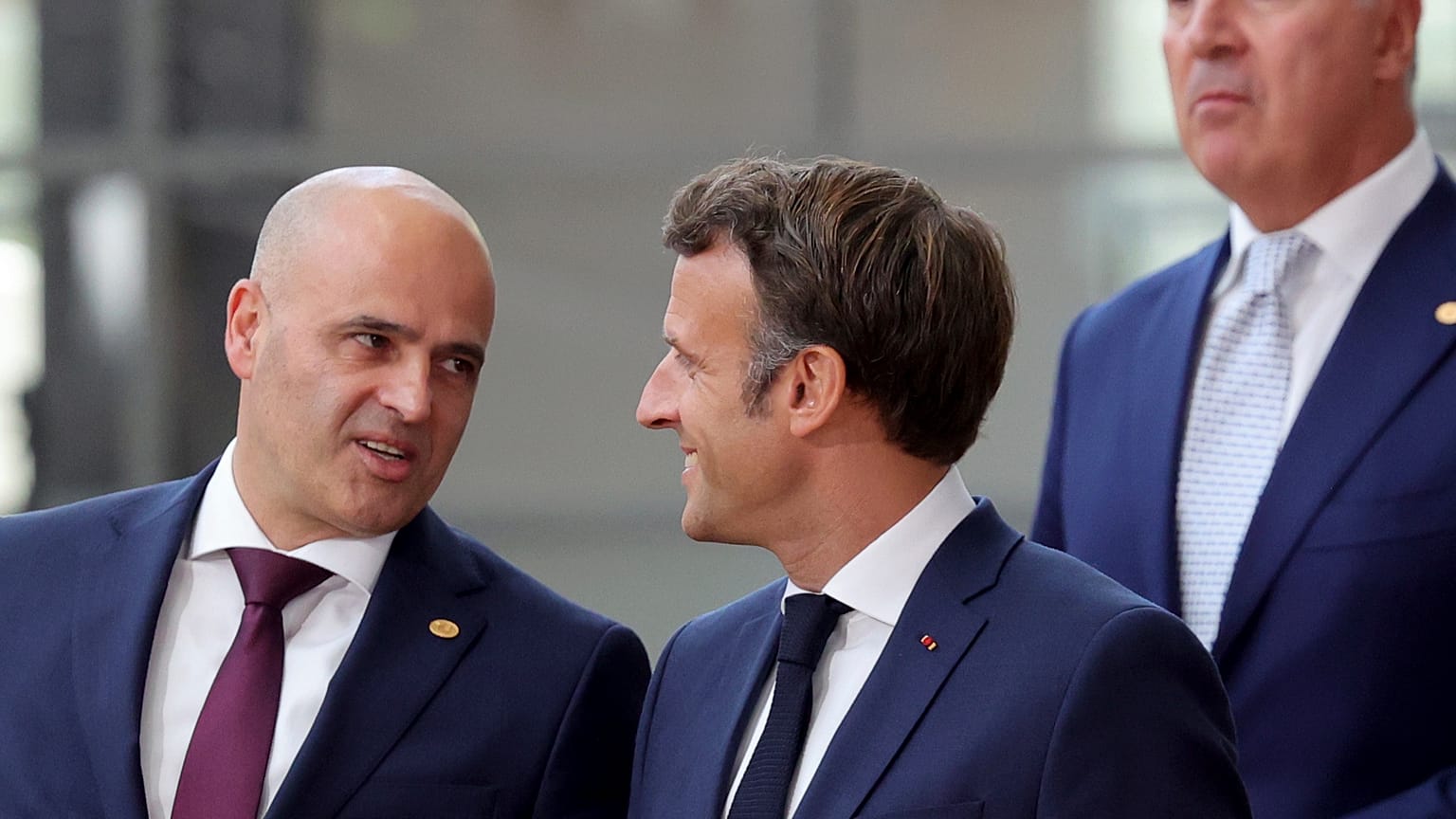 North Macedonia's Prime Minister Dimitar Kovacevski, left, speaks with French President Emmanuel Macron 
