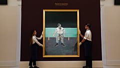 Members of the staff hold 'Study for Portrait of Lucian Freud' by Francis Bacon at Sotheby's, in London