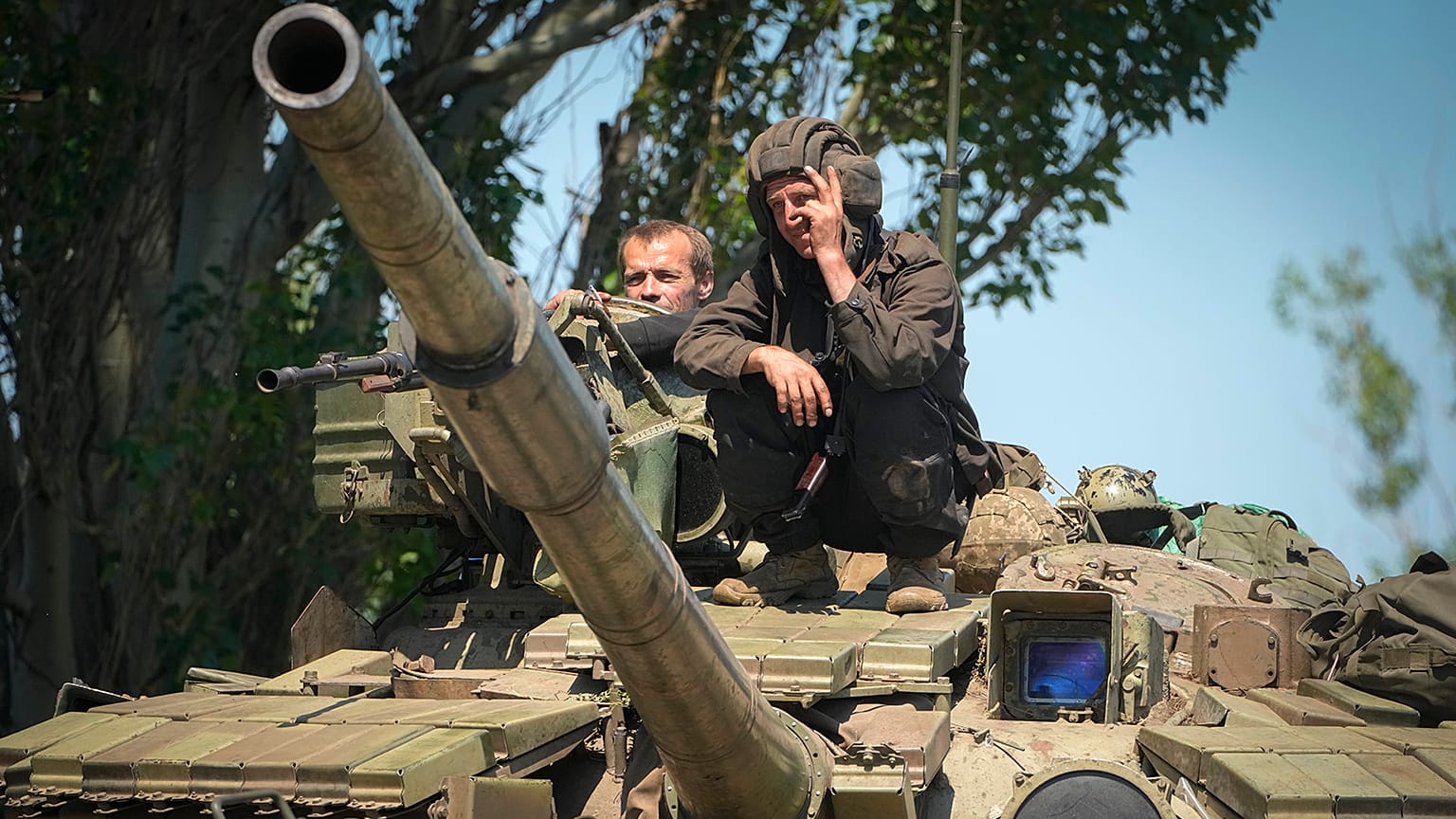 A Ukrainian soldier flashes the victory sign atop a tank in Donetsk region, 20 June 2022