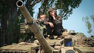 A Ukrainian soldier flashes the victory sign atop a tank in Donetsk region, 20 June 2022