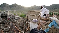 Un homme se tient parmi les destructions après le tremblement de terre dans le village de Gayan, dans la province de Paktika, en Afghanistan, jeudi 23 juin 2022. 