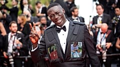 Khaby Lame poses for photographers upon arrival at the premiere of the film 'Top Gun: Maverick' at the 75th international film festival, Cannes, southern France (2022).