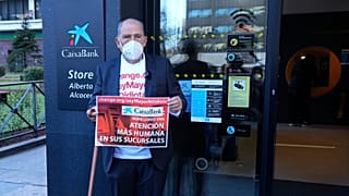 Carlos San Juan, 78, a Spanish retiree poses outside a bank in Madrid, Spain Tuesday Feb. 8, 2022.
