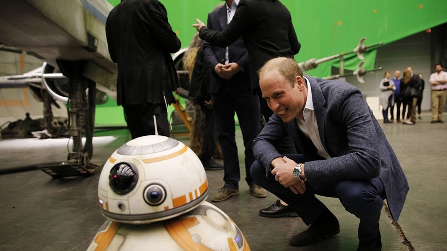 Britain's Prince William, Duke of Cambridge smiles at BB-8 droid during a tour of the Star Wars sets at Pinewood studios in Iver Heath, west of London on April 19, 2016.