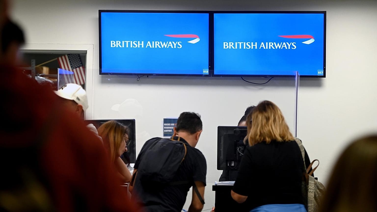 Passengers checking in at British Airlines departure terminal area at John F. Kennedy International Airport, New York City. 