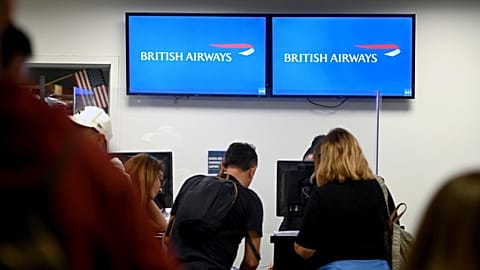 Passengers checking in at British Airlines departure terminal area at John F. Kennedy International Airport, New York City. 