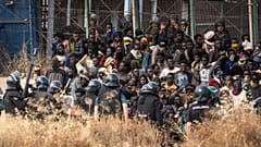 Riot police officers cordon off the area after migrants cross fences separating the Spanish enclave of Melilla from Morocco in Melilla, Spain, June 24, 2022.
