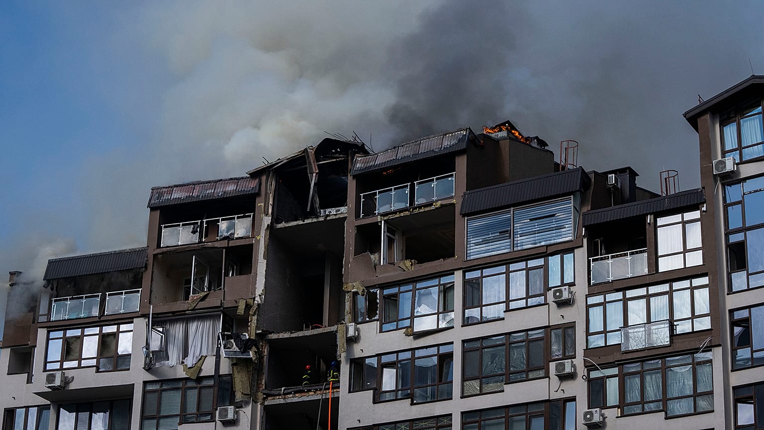 Smoke billows the air from a residential buildings following explosions, in Kyiv, 26 June 2022