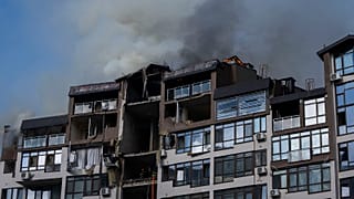 Smoke billows the air from a residential buildings following explosions, in Kyiv, 26 June 2022