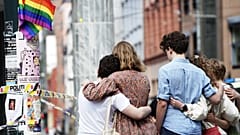 Young people mourn at a crime scene in central Oslo, Norway, on June 25, 2022, in the aftermath of a shooting outside pubs and nightclubs.