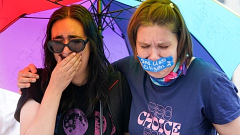 Abortion-rights activists in the US react after hearing the Supreme Court decision on abortion outside the Supreme Court in Washington, Friday, June 24, 2022.
