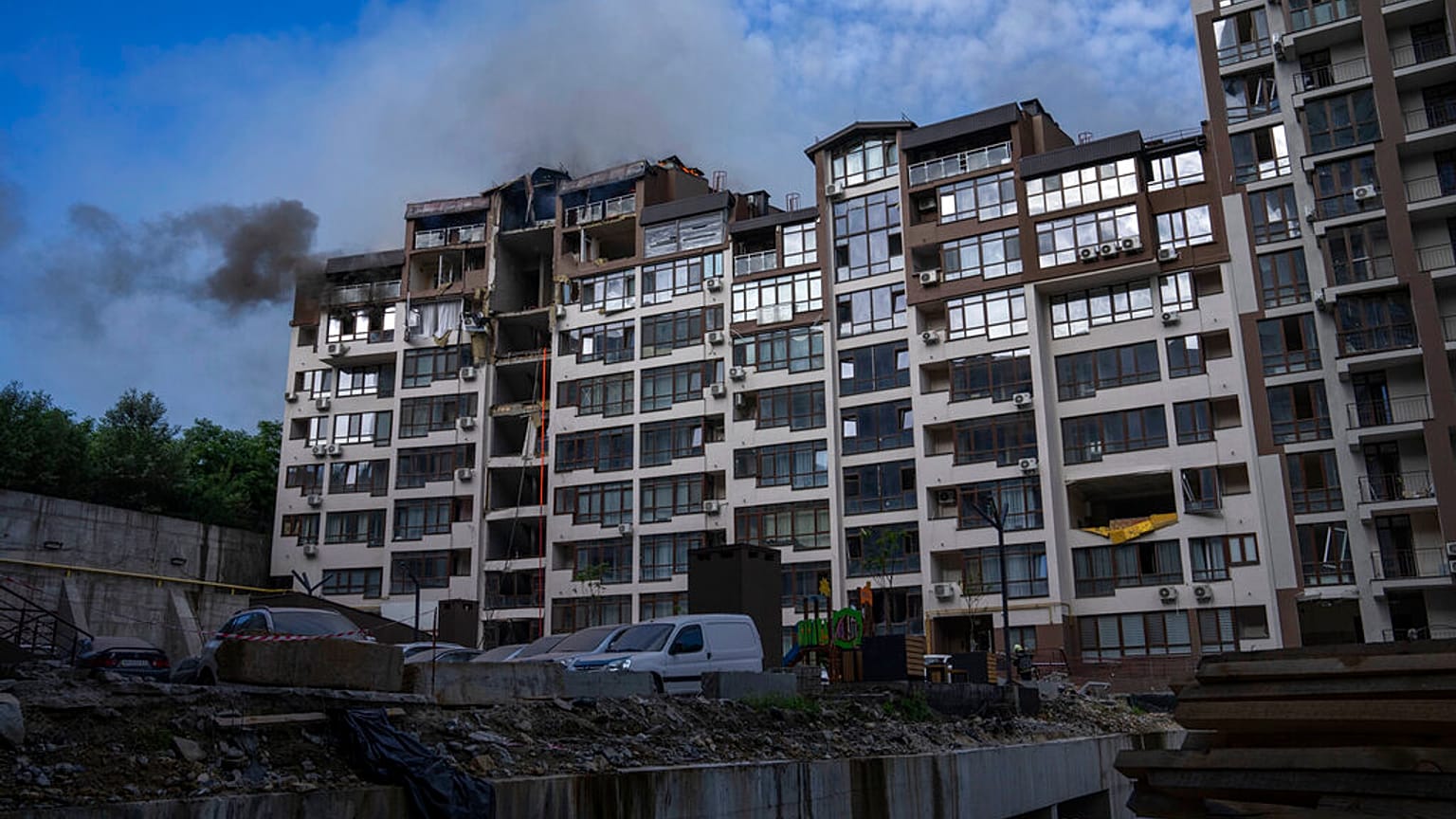 Smoke billows the air from a residential buildings following explosions, in Kyiv, Ukraine, June 26, 2022.