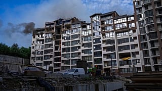 Smoke billows the air from a residential buildings following explosions, in Kyiv, Ukraine, June 26, 2022.