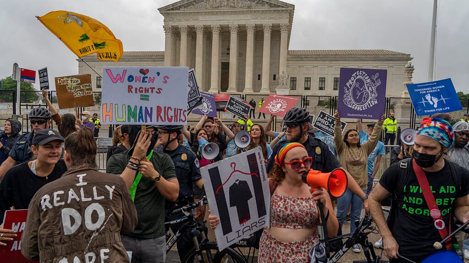 Abortion-rights protesters and anti-abortion protesters, divided by a police line