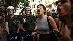 People shout slogans next to Turkish police officers during the LGBTQ Pride March in Istanbul, Turkey, Sunday, June 26, 2022.