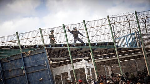 Ripped clothing and sticks are seen stuck on barbed wire at the border post of Barrio Chino that separates the Moroccan town of Nador from the Spanish enclave of Melilla.