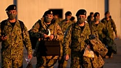 Soldiers walk to board an airplane after a farewell ceremony for departing troops, at the military airport in Lisbon, Friday, April 15, 2022