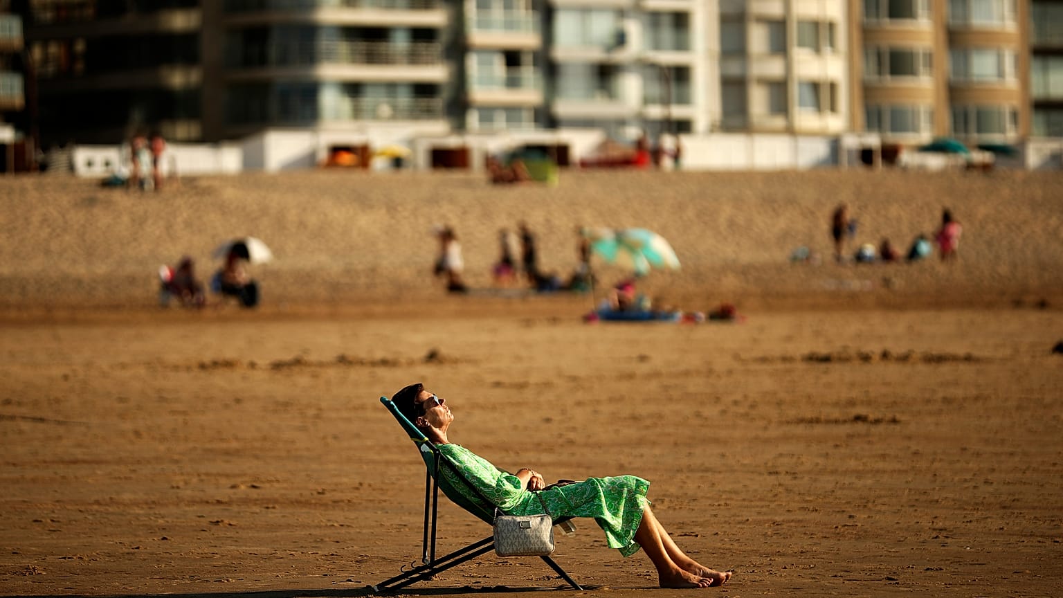 A woman sunbathes during a hot summer day at Zoute beach in Knokke-Heist, north Belgium, Friday, July 31, 2020.