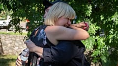People react at a shopping center burned after a rocket attack in which dozens of people are feared killed and injured, Kremenchuk, Ukraine, Tuesday, June 28, 2022.