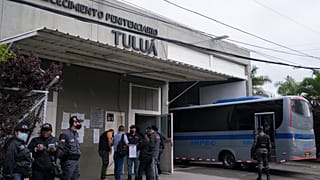 Jail officials and security forces gather outside a jail that suffered a deadly fire in Tulua.