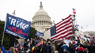 Violent insurrectionists loyal to President Donald Trump stand outside the U.S. Capitol in Washington on Jan. 6, 2021.