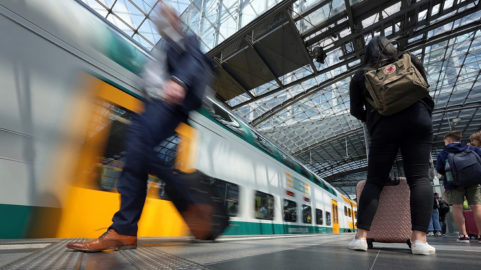 Travellers wait on a platform as a train arrives at the main train station in Berlin, Germany, Wednesday, June 1, 2022.