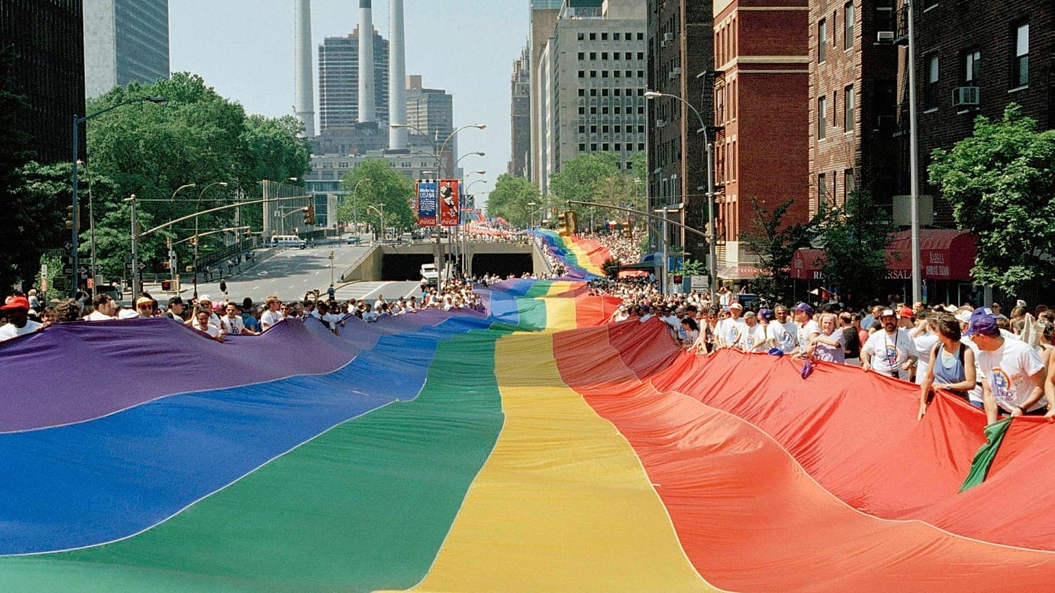 A mile-long rainbow is carried past the United Nations secretariat building during a march to commemorate the 25th anniversary of the stonewall riots Sunday, June 26, 1994