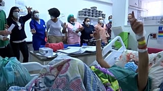 "Doctors of Joy" playing instruments and singing, medical staff and patients in hospital.